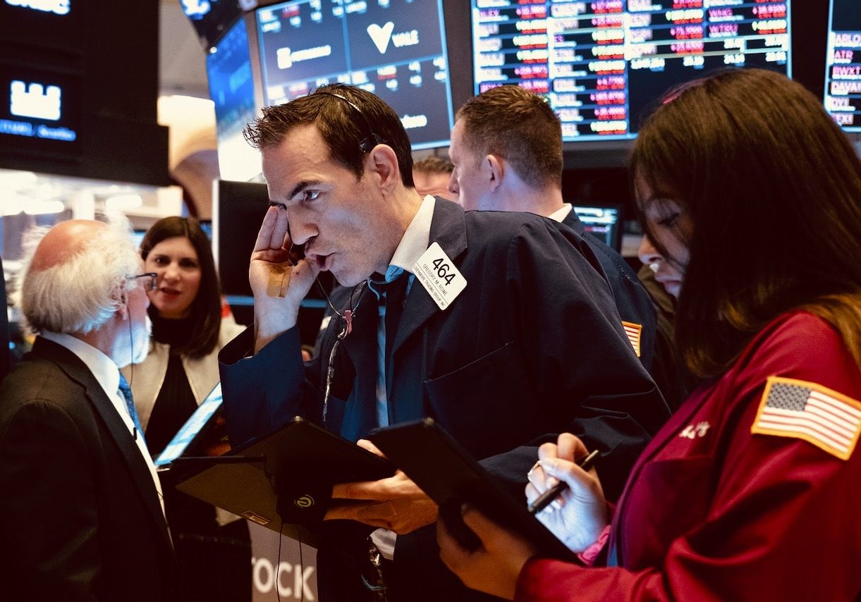 Trader Gregory Rowe, center, and others work on the floor of the New York Stock Exchange Monday, March 16, 2020. (AP Photo/Craig Ruttle)
